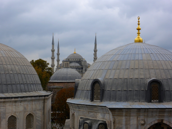 Sultan Ahmet Camii (The Blue Mosque) in the background, past the domes of 3 of the Turbes in the grounds of Haghia Sophia