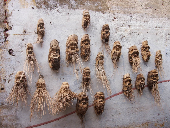 Wooden masks on a wall in Hoi An, Vietnam