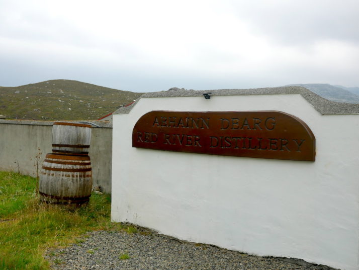 Abhainn Dearg (Red River) distillery sign board and 2 whisky barrels